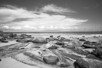 Fototapeta na wymiar Black and white picture of rocky beach background.