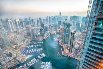 DUBAI, UAE - DECEMBER 6, 2016: Aerial view of Dubai Marina at sunset. Skyscrapers along the canals