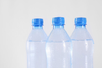 Plastic bottles with pure water on white background