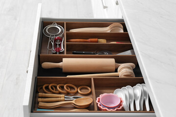 Drawer with utensil set, closeup. Order in kitchen