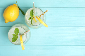 Natural lemonade with mint on light blue wooden table, flat lay and space for text. Summer refreshing drink