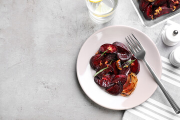 Roasted beetroot slices served on light grey table, flat lay. Space for text