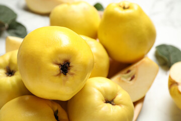 Fresh ripe organic quinces on table, closeup