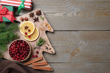 Flat lay composition with fresh ripe cranberries on wooden table. Space for text