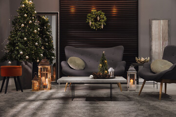 Elegant living room interior with comfortable sofa and Christmas decor