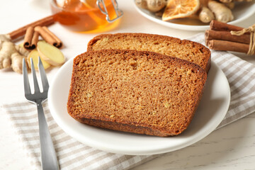Fresh gingerbread cake slices served on white wooden table, closeup