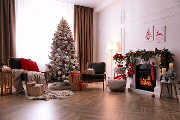 Stylish room interior with fireplace and beautiful Christmas tree