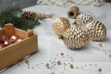 Composition with beautiful Christmas baubles on white wooden table