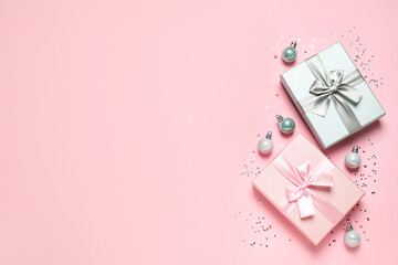 Beautiful gift boxes, Christmas balls and confetti on pink background, flat lay. Space for text