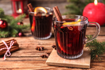 Aromatic mulled wine on wooden table, space for text