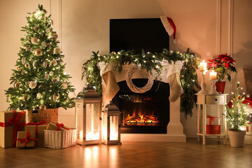 Beautiful room interior with fireplace and Christmas decor in evening