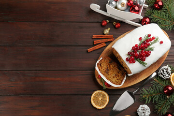 Flat lay composition with traditional classic Christmas cake on wooden table. Space for text