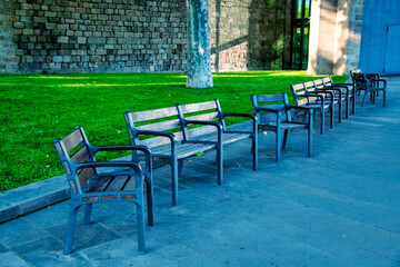 Fototapeta na wymiar Empty chairs in a city park