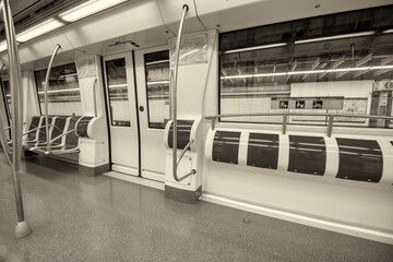 Interior of subway train with empty seats.