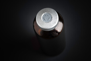 Macro Image Of Amber Vaccine Vial In Black Background