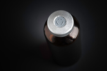 Macro Image Of Amber Vaccine Vial In Black Background
