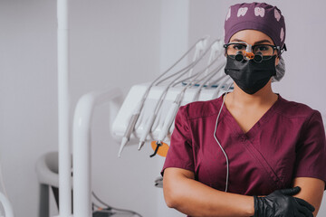 Young blond Caucasian female opening her mouth while African-American ethnic dentist in white latex gloves check condition of her teeth focus on dentist