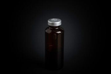 Macro Image Of Amber Vaccine Vial In Black Background