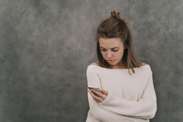 The girl holds the phone in her hands. Dependence on social networks. All life in gadgets