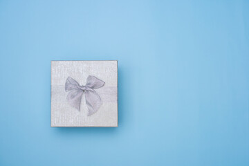 Simple white gift box isolated on blue background.