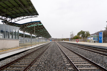 Naklejka premium Paju, South Korean - April 10, 2019: Platform and railway tracks at Dorasan Station on the Gyeongui Line in Paju, South Korean, which used to connect North Korea and South Korea.