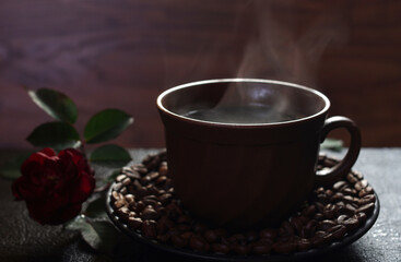 Hot coffee cup with steam smoke on dark background.