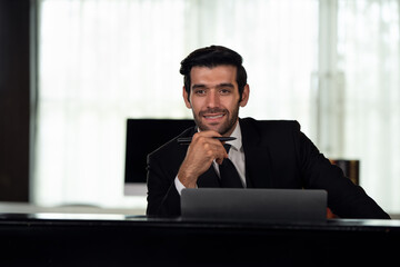 Portrait of young handsome confident businessman in suit