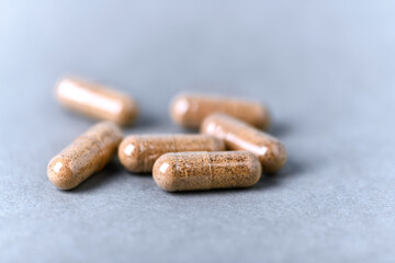 Ashwagandha (Withania somnifera) capsules on paper background. Close up.