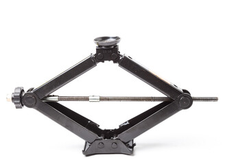 Black metal jack for replacing a car wheel on a white isolated background in a car service....