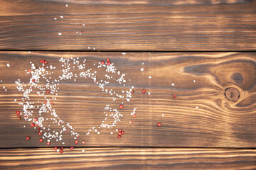 Top view of a cutting Board sprinkled with salt and pepper.