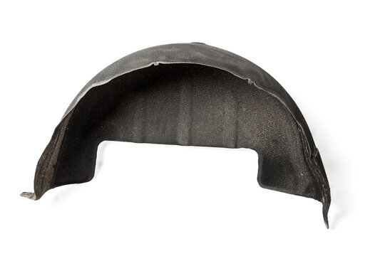 Black plastic liner on a white isolated background in a photo studio for sale or replacement in a car service. Mudguard on auto-parsing for repair or a device to protect the body from dirt.