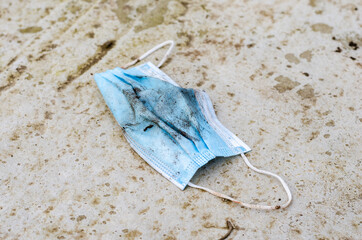 Forgotten  or  discarded surgical mask on ground