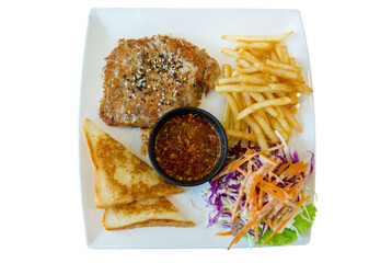 Grilled pork, roasted pork or Barbecued pork with salad and French fries with Spicy Dipping Sauce on white isolated.