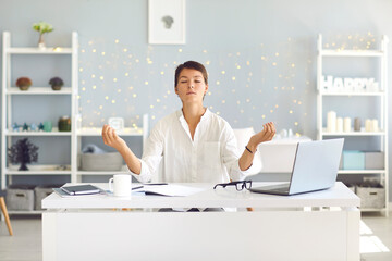 Tired woman sitting in office practicing meditation technique for concentration and restoring energy