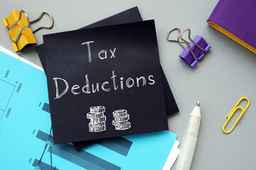 Business concept meaning Tax Deductions with inscription on the sheet.