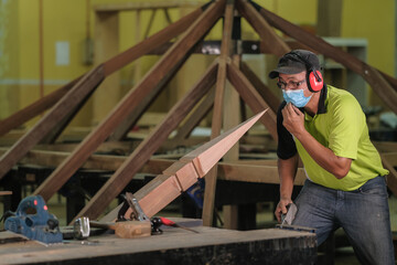 Carpenter making Tunjuk Langit or one of the roof structures. Hip Roof
