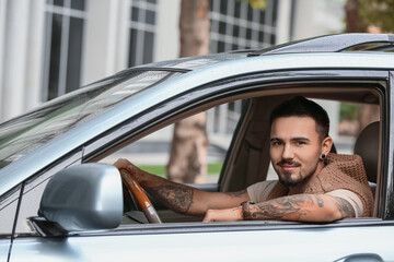 Naklejka premium Handsome man driving modern car