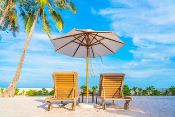 Umbrella and deck chair around outdoor swimming pool in hotel resort