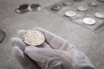 Numismatics. Old collectible coins made of silver on a wooden table.
