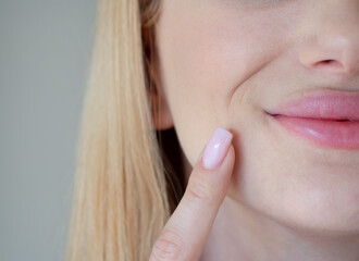 
the girl has wrinkles around her mouth