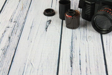 Old photo camera with flash mounted on a wooden background and retro environment, with space to place text