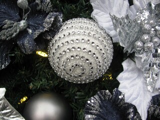 Decorative Christmas tree with a sparkling silver ball