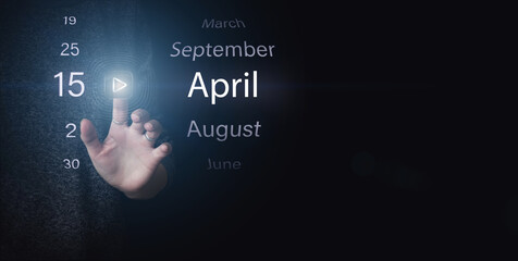 April 15th. Day 15 of month, Calendar date. Hand click luminous icon PLAY and DATE on dark blue background. Spring month, day of the year concept.