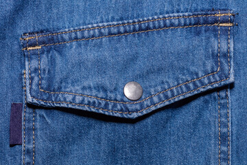 Close up shot of pocket of blue denim jeans shirt. Clothing store and shopping concepts