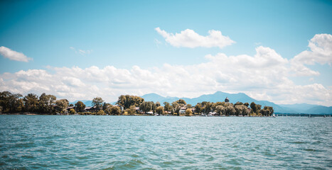 Sailing on lake Chiemsee in Bavaria on a sailing boat on a warm summer day with lots of wind in sails