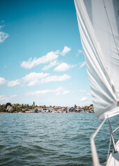 Sailing on lake Chiemsee in Bavaria on a sailing boat on a warm summer day with lots of wind in...