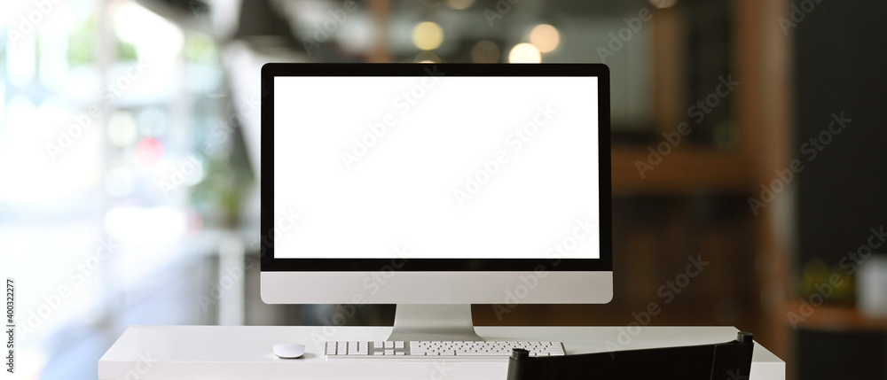 Poster front view of a computer with blank on white table at contemporary office.