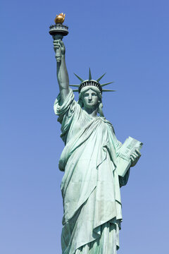 Statue of Liberty in front of blue sky
