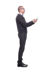 casual young man is pointing to his side while speaking on the phone and smiling to the camera