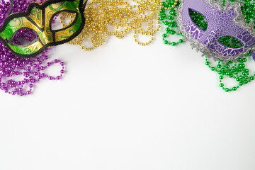 Mardi gras background on white with masks and beads and copy space